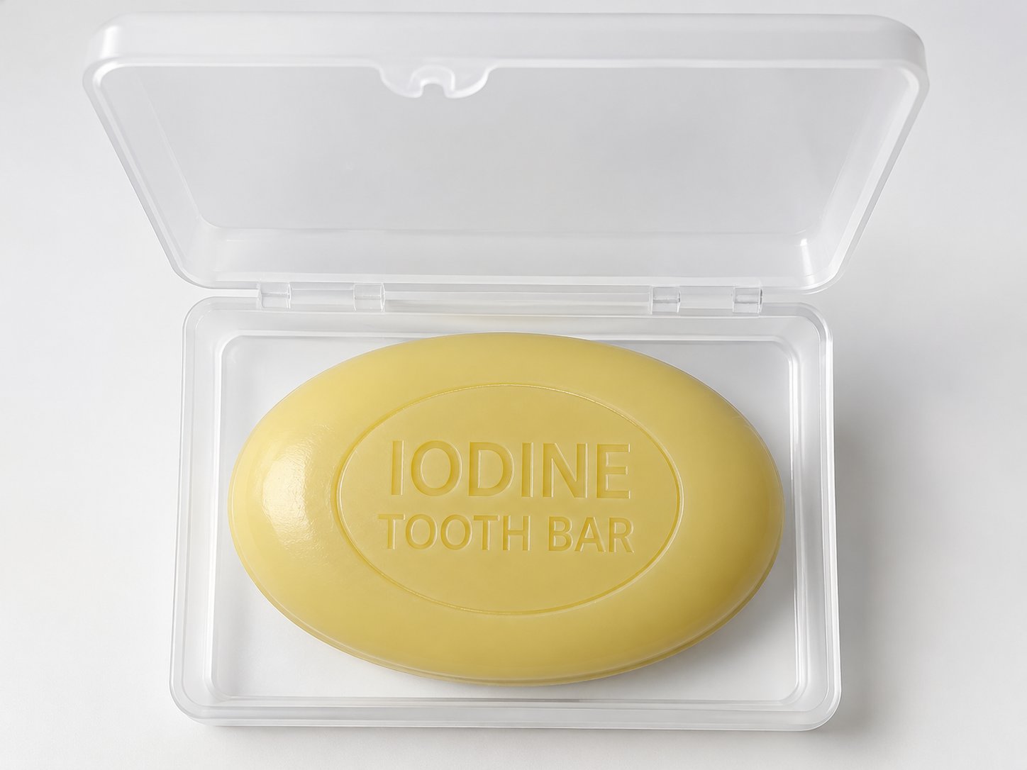 The oval, cream-colored Iodine Tooth Bar embossed IODINE TOOTH BAR, resting in its reusable travel case